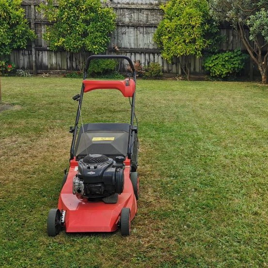 Four Seasons Lawn Care mowing a lawn in Gisborne